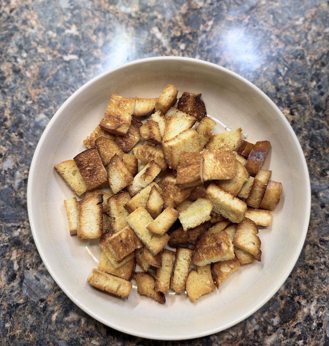 Golden homemade garlic-infused croutons